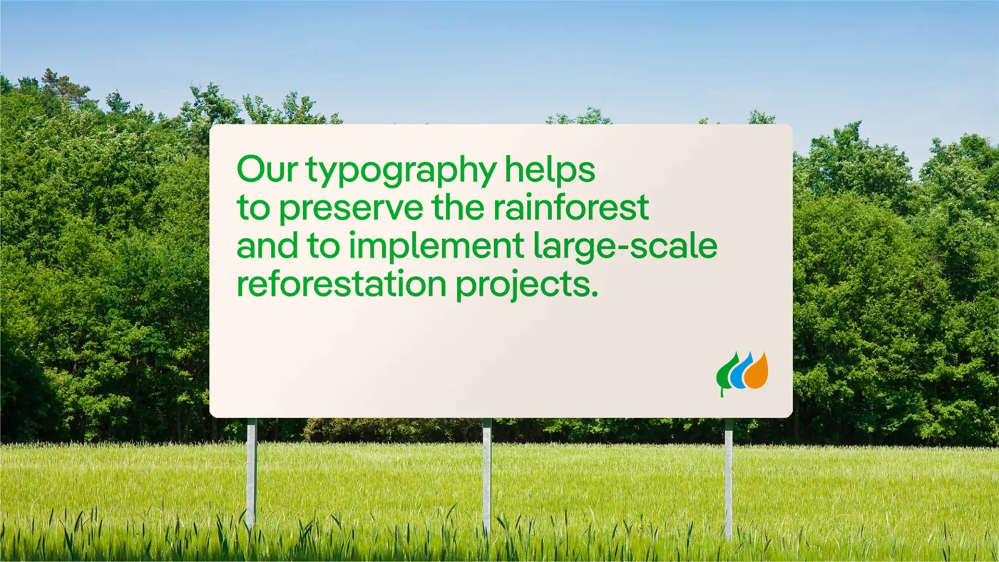 Cartel con logotipo de Iberdrola y leyenda "Nuestra tipografía ayuda a preservar la selva tropical y a implementar proyectos de reforestación a gran escala"